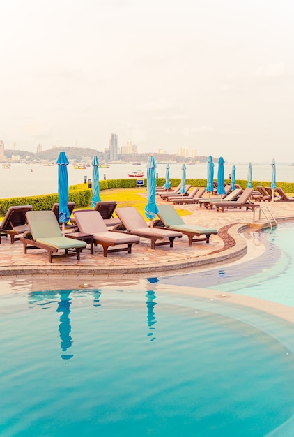 Premium Photo Pool Beds And Umbrellas Around Swimming Pool