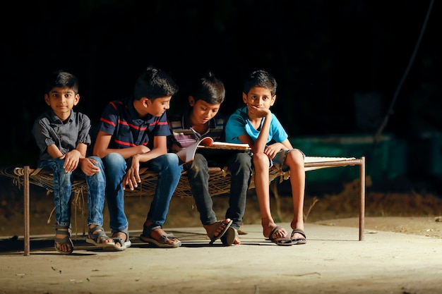 kid doing homework under street light