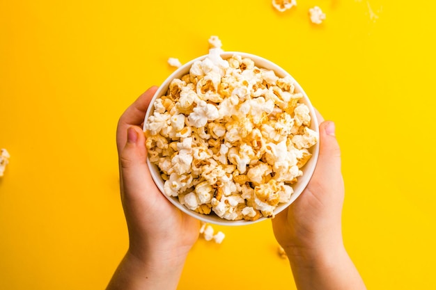 Premium Photo | Popcorn viewed from above on yellow background. child ...