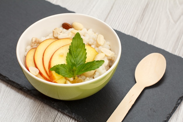 Premium Photo | Porcelain bowl with sorghum porridge with fresh peach ...