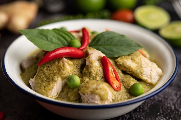 Free Photo | Pork green curry in a white bowl with spices on a black ...