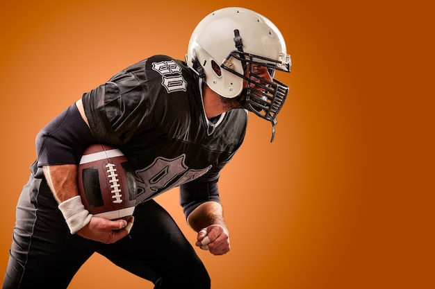 Premium Photo Portrait Of American Football Player With Helmet Close Up On Brown Background