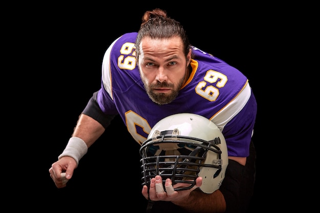 Premium Photo Portrait Of American Football Player With Helmet In Hand Close Up