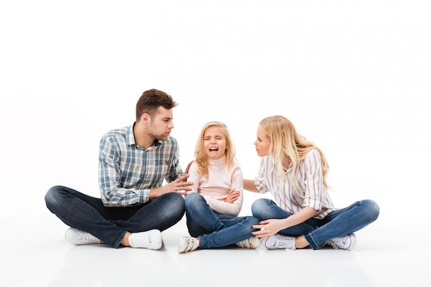 Portrait of a angry family sitting together Free Photo