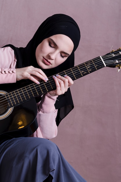 Free Photo | Muslim woman playing on the guitar