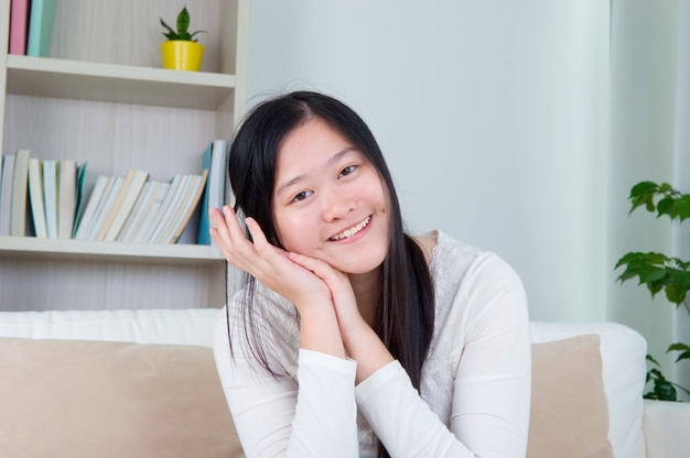 Premium Photo Portrait Of Asian Girl Hand Holding Face Relaxed And Smiling At Home Adult