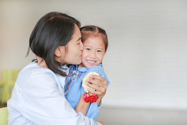 Premium Photo Portrait Of Asian Mom Kissing And Hugging Her Daughter