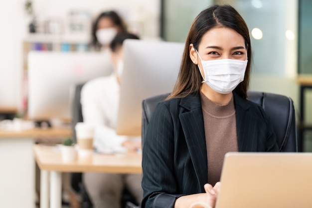Premium Photo | Portrait of asian office employee businesswoman wear  protective face mask work in new normal office