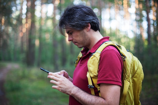 Premium Photo | Portrait of backpacker looking at gps navigator, global ...