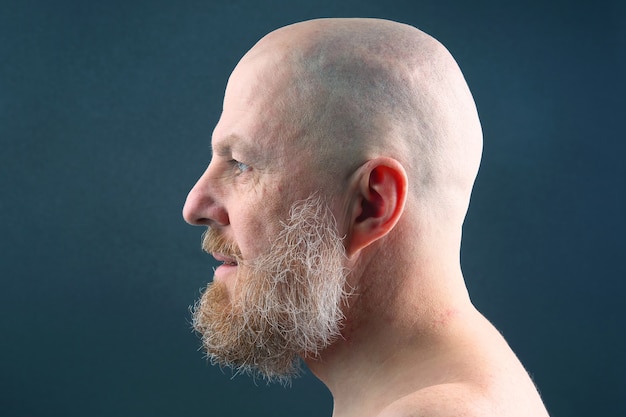 Premium Photo | Portrait of a bearded and bald man in profile