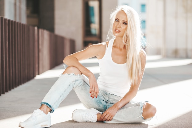 Portrait Of Beautiful Cute Blond Girl In White T Shirt And Jeans