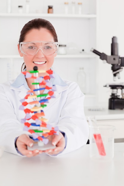 Premium Photo Portrait Of A Beautiful Scientist Showing The Dna