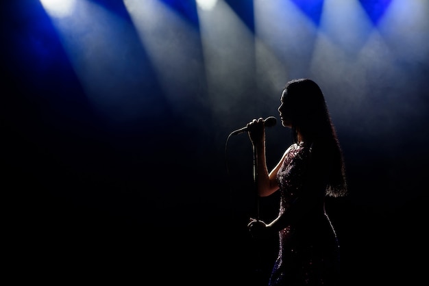 Premium Photo Portrait Of Beautiful Singing Woman On Dark Background