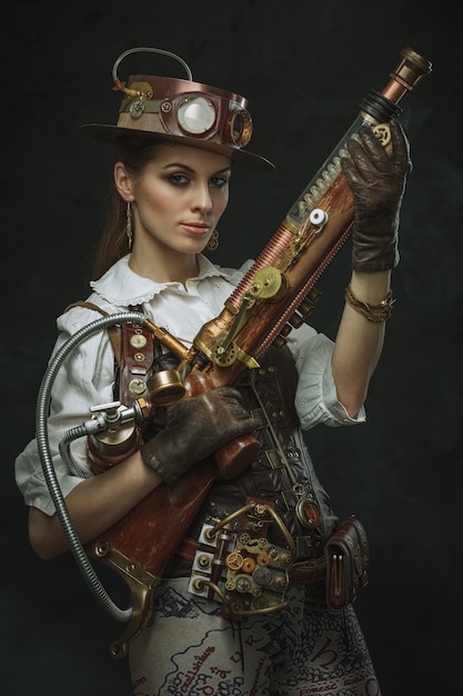 Premium Photo Portrait Of A Beautiful Steampunk Woman Holding A Gun