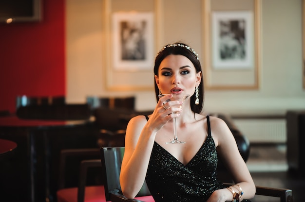 Premium Photo | Portrait of beautiful woman holding glass of martini