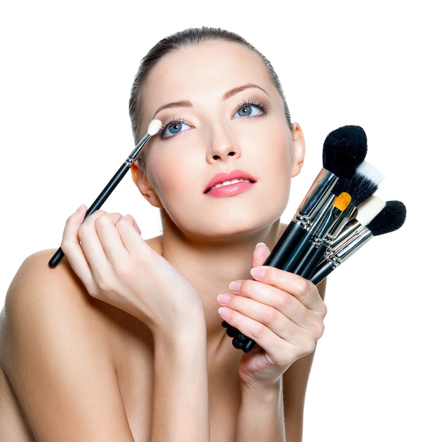 Free Photo | Portrait of the beautiful woman with make-up brushes near ...