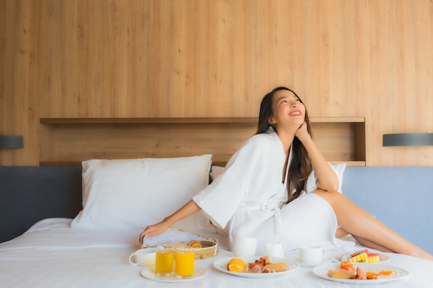 portrait beautiful young asian woman happy enjoy with breakfast bed bedroom 74190 10030 - 5 Tips Tentukan Hotel di Malaysia sesuai Budget dan Nyaman