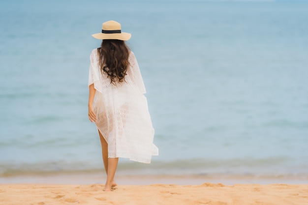 Portrait beautiful young asian woman smile happy relax on the beach sea ocean Free Photo