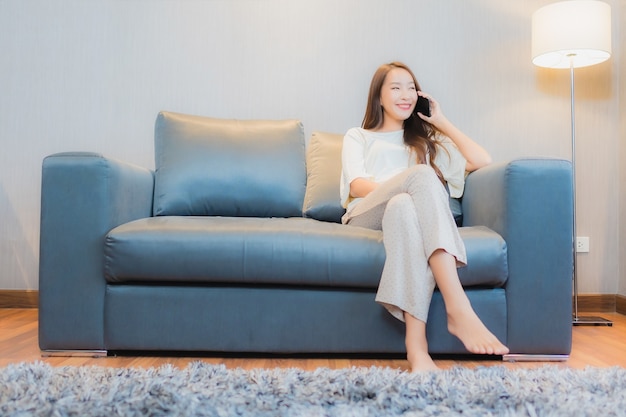 Free Photo Portrait Beautiful Young Asian Woman Use Smart Mobile Phone On Sofa In Living Room Interior