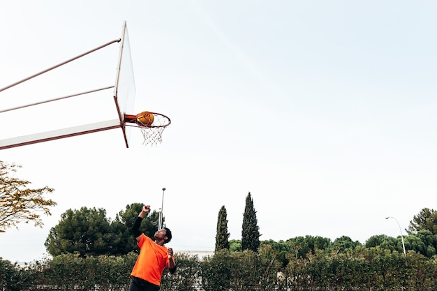 Premium Photo Portrait Of A Black Afro Boy Jumping Into The Basket To Shoot The Ball Playing Basketball On An Urban Court