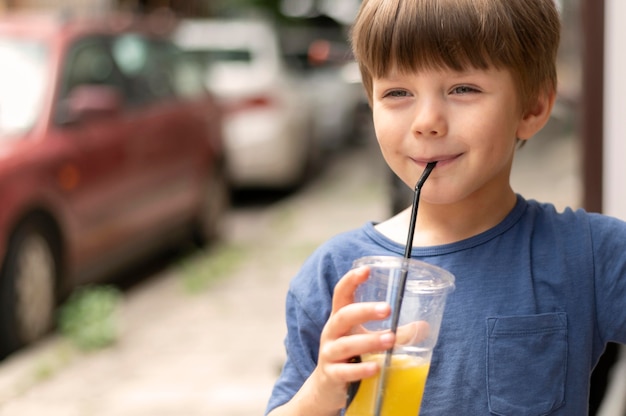 Portrait boy drinking juice | Free Photo