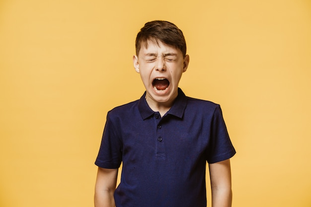 Premium Photo Portrait Of A Boy Screaming Out Loud With Eyes Closed