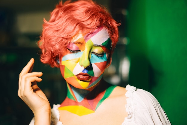 Portrait Of A Bright Woman With Orange Hair And Multi Color Makeup