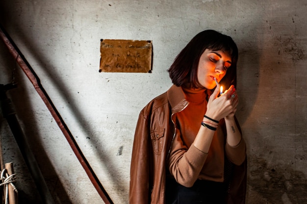 Premium Photo | Portrait of a brunette girl lighting a cigarette 3