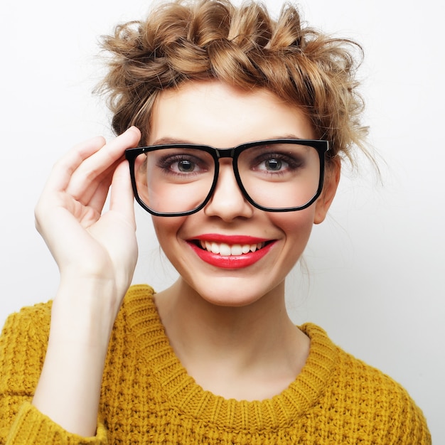 Premium Photo Portrait Of A Casual Woman In Glasses Looking At Camera Isolated On A White 2014