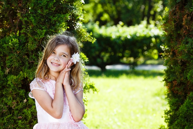 Premium Photo Portrait Of A Cheerful Girl In A Lush Pink Dress In The Park 