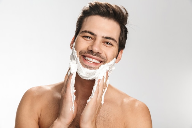 Premium Photo Portrait Of Cheerful Half Naked Man Applying Shaving