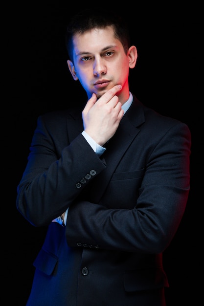 Portrait of confident handsome stylish businessman touching his chin Premium Photo