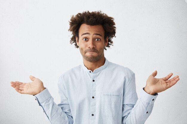 Free Photo | Portrait of confused male standing against white studio ...