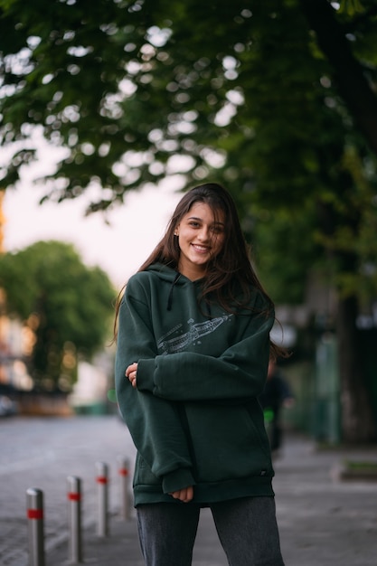 Portrait of cute  girl with long  hair  in city on street 