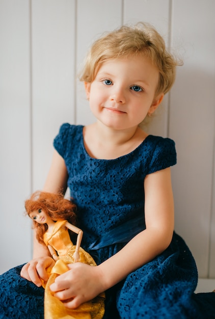 Premium Photo | Portrait of cute little girl holds her lovely barbie ...