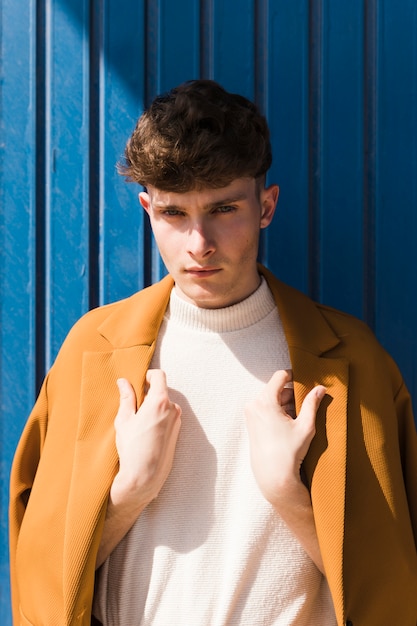 Free Photo | Portrait of fashionable boy against blue wall