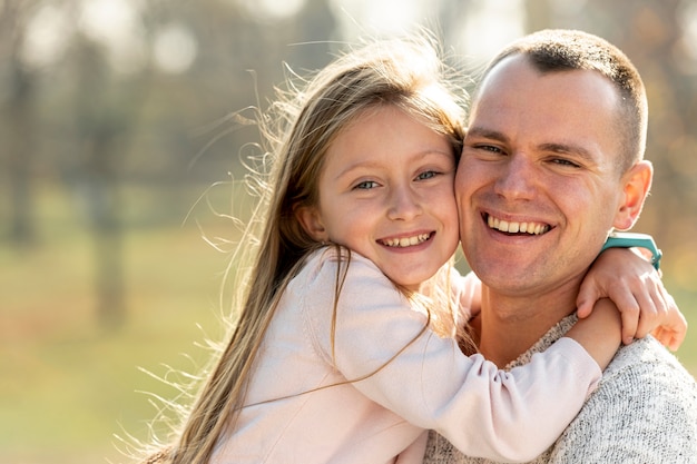 Free Photo Portrait Of Father And Daughter Looking At Photographer
