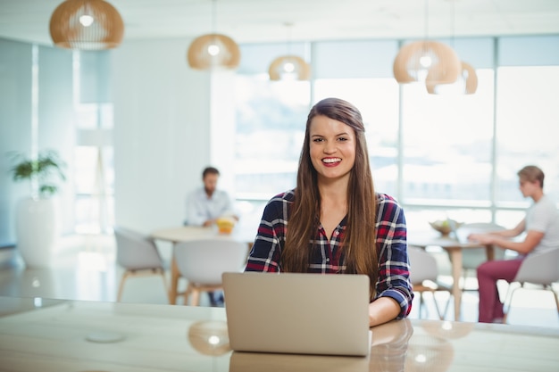 Premium Photo | Portrait of female business executive using laptop