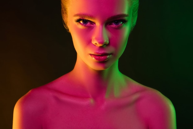 Premium Photo | Portrait of female fashion model in neon light on dark ...