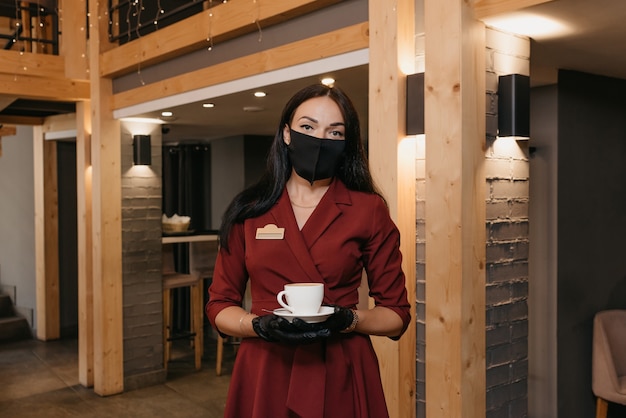 Portrait female waitress serving coffee Premium Photo