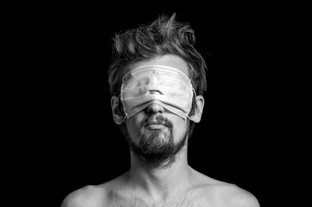 Premium Photo | Portrait of a guy on a black background, a mask on his eyes