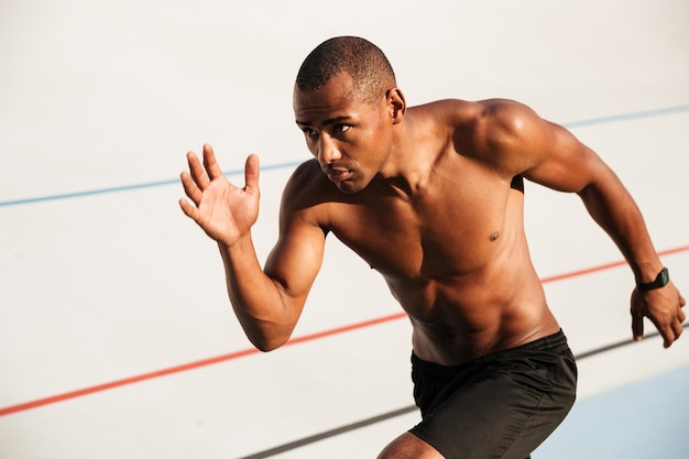 Portrait Of A Half Naked Muscular Sportsman Running Free Photo