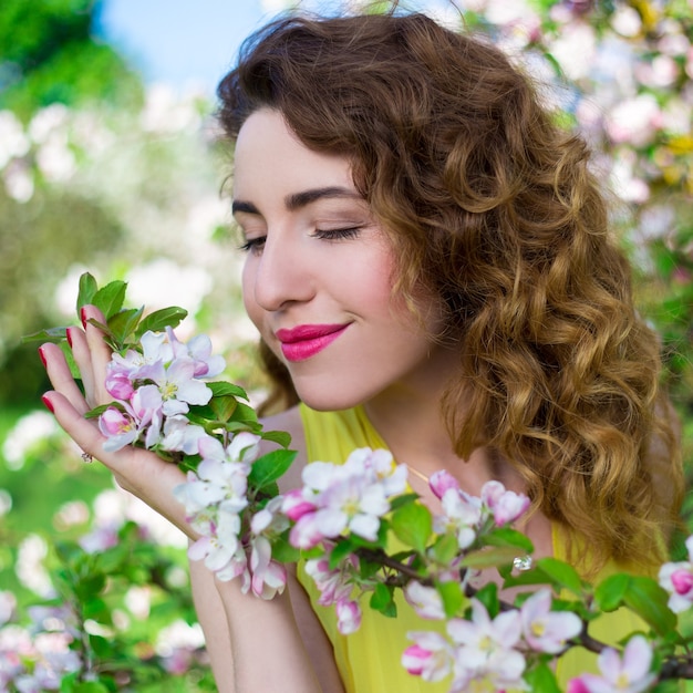 Premium Photo | Portrait of happy beautiful girl in blooming summer garden