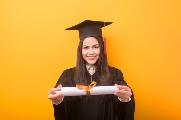 Premium Photo | Portrait of happy beautiful woman in graduation gown is ...