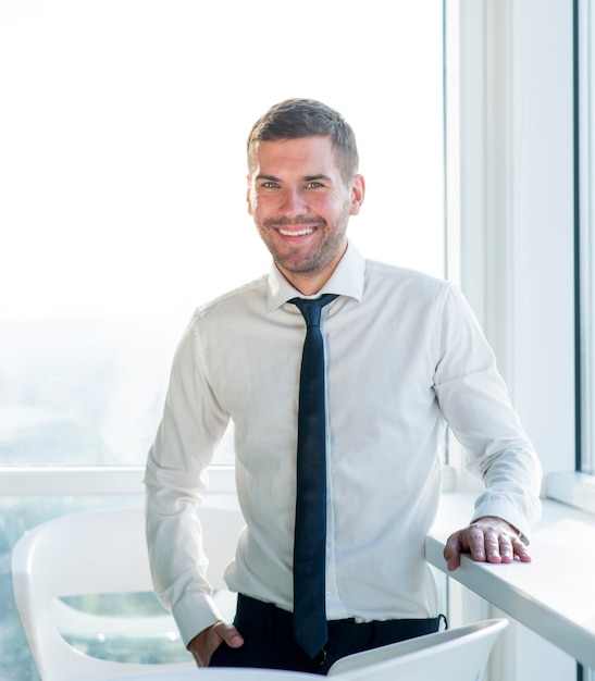 Free Photo Portrait of a happy businessman standing  in 