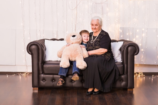 Portrait Of Happy Old Granny And Her Grandson Hugging Looking At