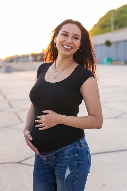 Premium Photo | Portrait of hispanic pregnant woman walking on ...