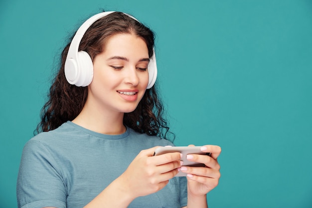 Premium Photo | Portrait of jolly young woman in wireless headphones ...