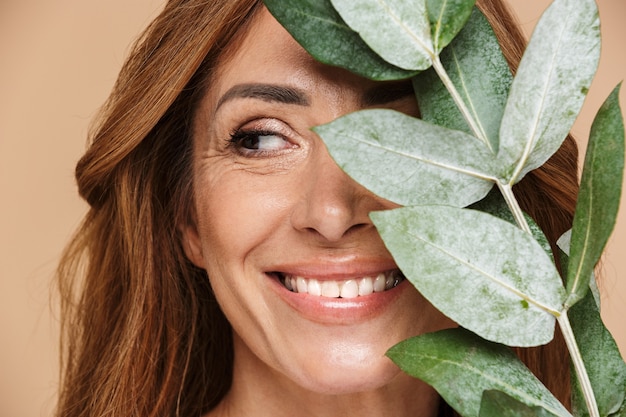 Premium Photo Portrait Of Joyful Adult Woman Posing With Eucalyptus