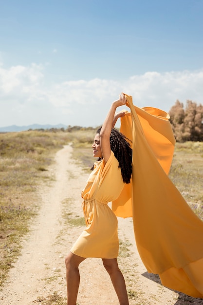Free Photo | Portrait of joyful woman with yellow cloth in nature